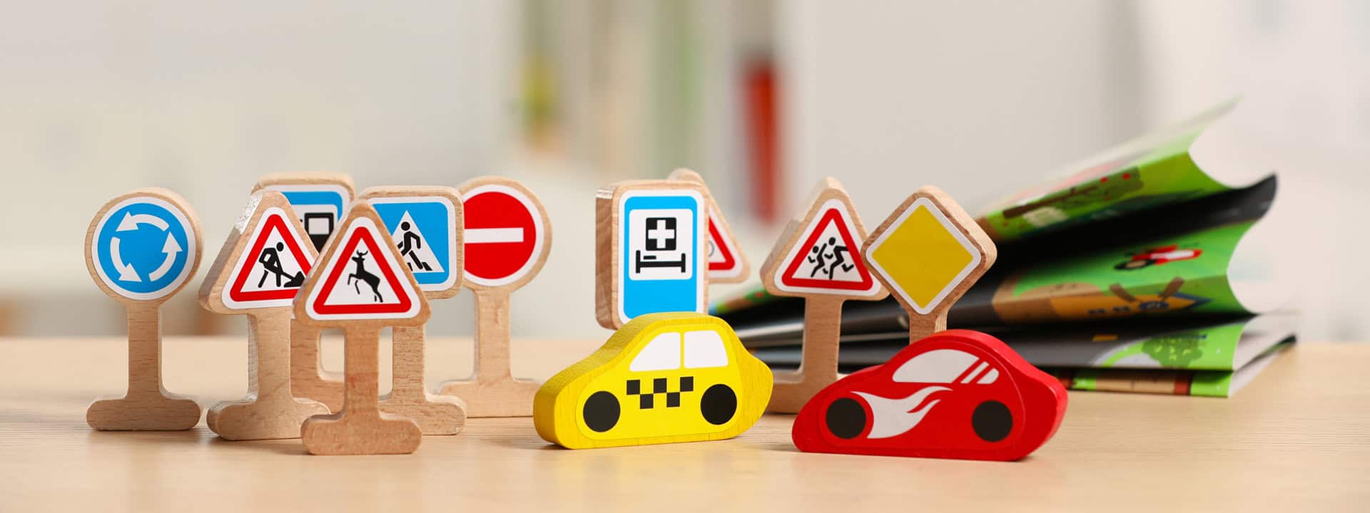 Childcare resource and referral signs with toy cars and books on a table.