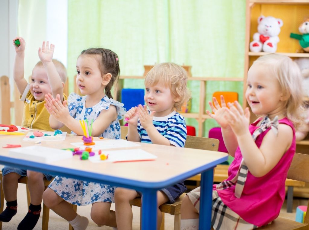 kids group learning arts and crafts in day care centre