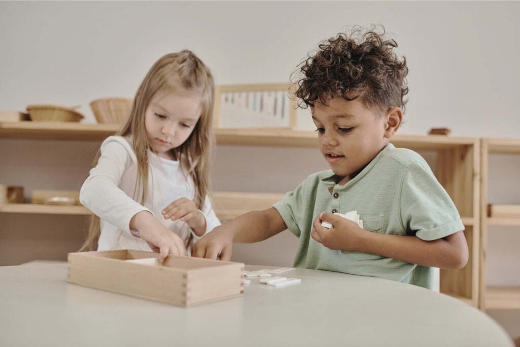 Children playing with educational toys in a childcare setting.