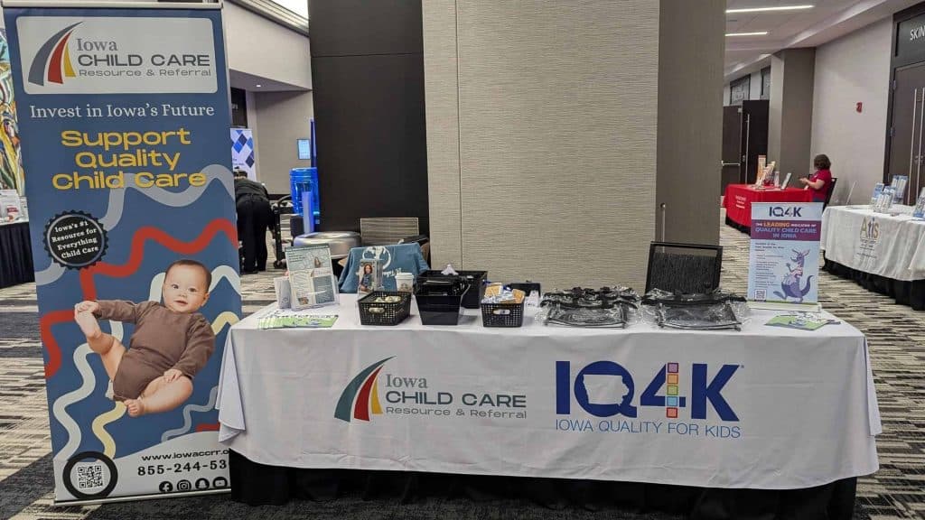 Iowa Child Care Resource & Referral booth at a conference with informational materials and banners.